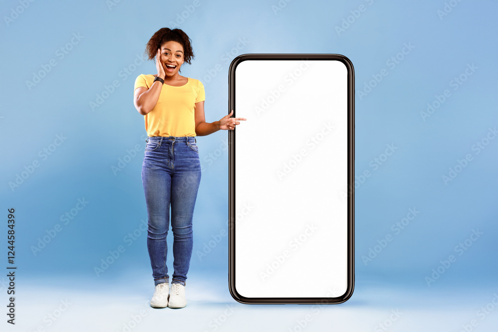 Poster emotional african american woman cannot believe great offer, pointing at big smartphone with space f