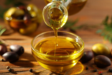 A premium olive oil with olives and fresh leaves, top view 