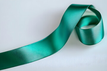 Green satin ribbon placed on the side of the image. Awareness month on brain injuries.