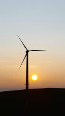 Obraz premium Wind power plant towers in mountains at sunset. Windmill farm. Sustainable energy production. Green energy, clean power, clean energy concept. 