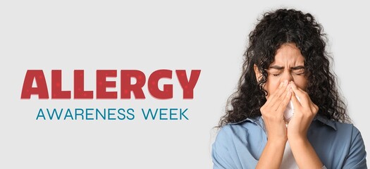 Banner for Allergy Awareness Week with young African-American woman blowing nose