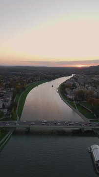 aerial flyover over vistula river in krakow at sunset in summer