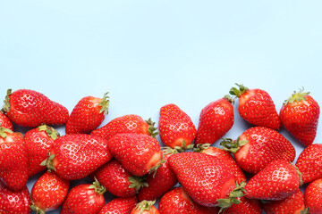 Fresh strawberries on blue background