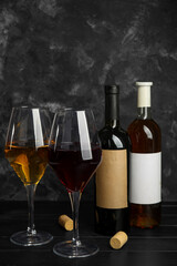 Bottles and glasses of exquisite wine on table