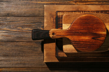 Different cutting boards on wooden background