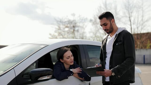 Driving instructor guides young woman during a practical training session with an electric vehicle. Ideal for learning, driving school promotions, and educational purposes