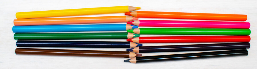 Colorful pencils in raw, pastel crayons.Creativity creation process.Artist's stuff.Top view Flatlay of drawing supplies