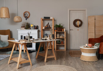 Interior of witch's room with magic attributes, table and shelf units