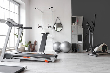 Interior of gym with modern sports equipment