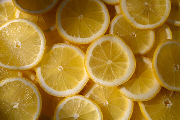 Bright yellow lemon slices arranged beautifully on a surface for a sunny, fresh look