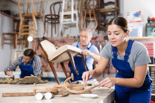 Portrait of skillful repair woman carpenter renovating chair furniture using tools in woodwork studio