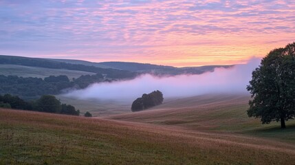 Obraz premium Serene Morning Landscape with Misty Hills and Colorful Sunrise