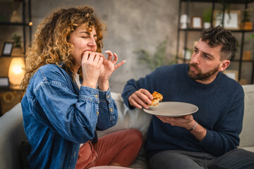 husband and wife eat pizza at home having time together with food