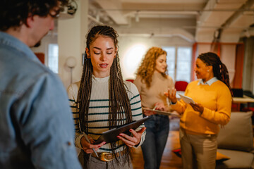 business woman exchanges information with male colleagues at office