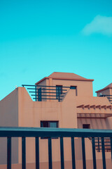 Tyipical canarian homes in Fuerteventura, Canary Islands, Spain. Beige colored little houses, terraced houses or town houses from the Eighties. Retro style vintage look.