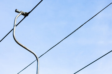 Abstract depiction of a ski lift cable system against blue sky