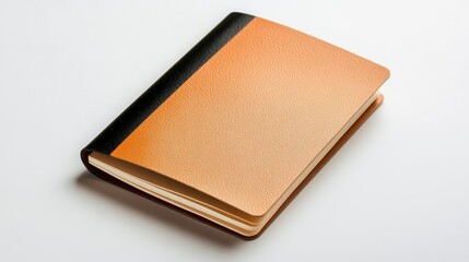 Fototapeta premium Small Tan and Black Speckled Notebook On White Background