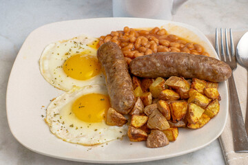two ried eggs top with parsley  with  sweet italian sauage