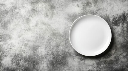 Empty Plate on Textured Surface: A clean, white plate rests on a textured gray surface, providing a simple yet elegant backdrop for your culinary creations.  