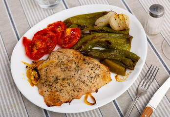 Spanish Secreto de cerdo - roasted pork served with stewed pepper and tomatoes
