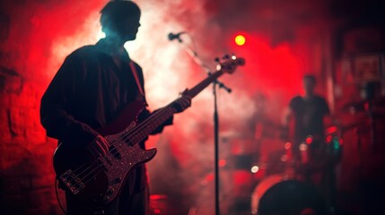 Obraz premium Passionate Bass Player in Red-Lit Concert.