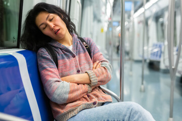 Portrait of sleepy Asian girl in a subway car