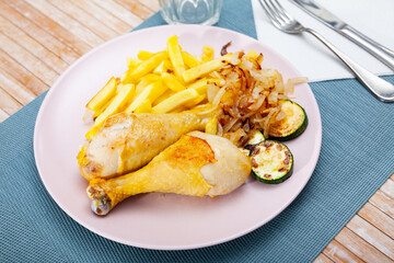 Delicious roasted chicken legs with roasted potatoes and zucchini