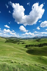Fototapeta premium A serene landscape featuring rolling green hills under a bright blue sky with fluffy clouds.