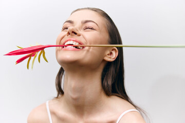 Happy young woman with flower smiling joyfully, creating a vibrant atmosphere and fresh mood....
