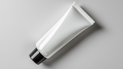 A sleek white cosmetic tube with a black cap, ideal for skincare or beauty products.