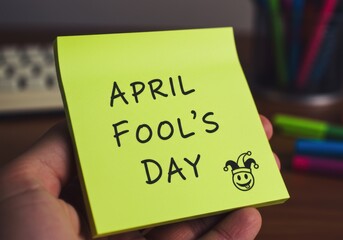 April fool's day note with jester drawing on bright yellow sticky paper