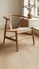 A wooden chair with a woven seat, placed in a minimalist interior space.