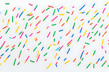 Colorful Sprinkles Scattered on White Background: A Vibrant and Festive Abstract Design