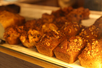 Delicious sweet pastries on display in cafe, closeup