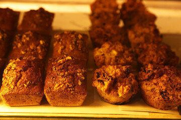 Delicious sweet pastries on display in cafe, closeup