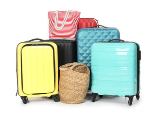 Many colorful suitcases and beach bags isolated on white