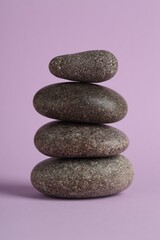 Stack of rocks on lilac background. Harmony and life balance