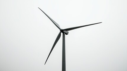 Wind turbine spinning against a cloudy sky in a renewable energy field