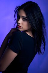 A confident woman’s silhouette glows in warm light as she plays with her dark hair.