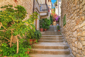 Mediterranean summer cityscape - view of a medieval street with stairs in the Old Town of Hvar, on...