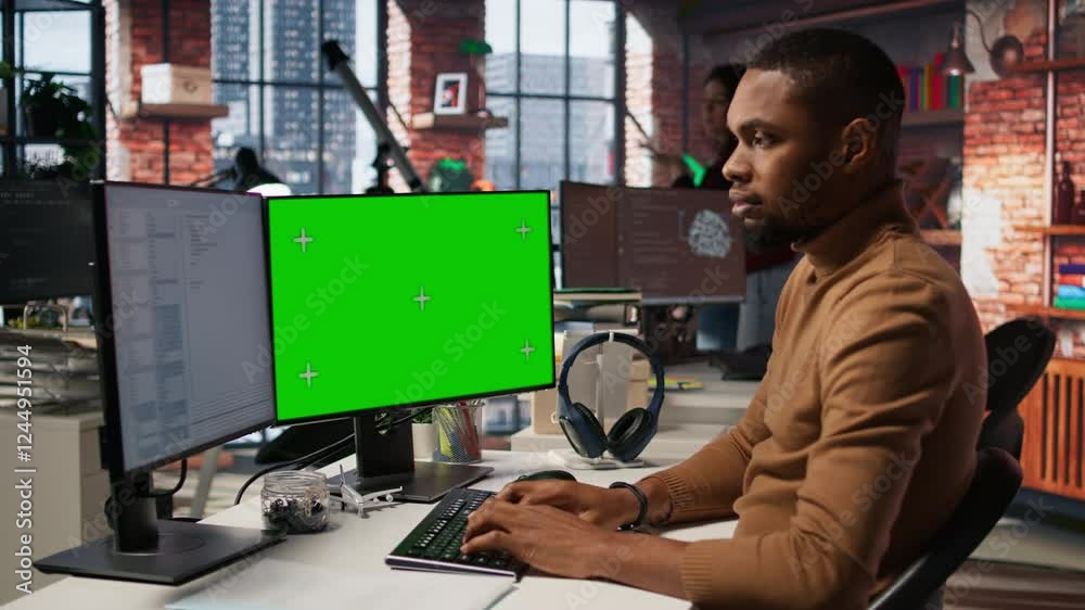 Poster programmer coding in startup office using green screen pc, building scalable solutions for businesse