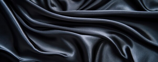 Fototapeta premium Rich black silk fabric background, showcasing its luxurious drapery and smooth texture with a subtle matte sheen, ideal for elegant presentations.