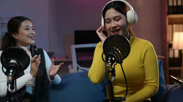 Two women enjoying a podcast recording session together