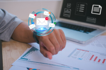 Young businessman wearing smart watch working on computer checking email in concept of communication customer services support and marketing