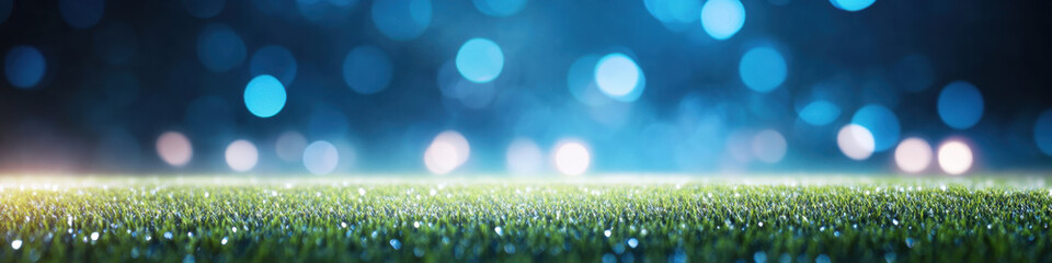 Obraz premium vibrant green grass field illuminated by soft blue bokeh lights creates magical atmosphere, perfect for sports or outdoor events