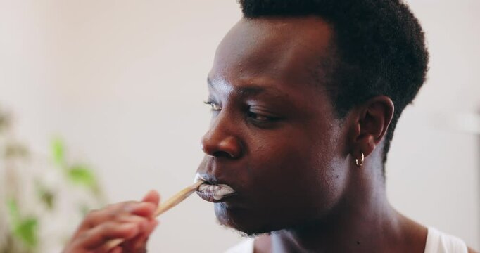Dental, brushing teeth and mouth with black man in bathroom for cleaning, oral hygiene and morning routine. Wake up, wellness and self care with person and toothbrush at home for gum health