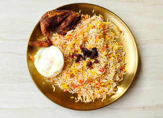 Nasi Kebuli ayam goreng, Spice Arabian Rice with Clove, Cinnamon, and Garlic. Kabli Rice with fried...