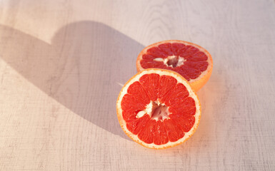 Grapefruit halves on wooden table.