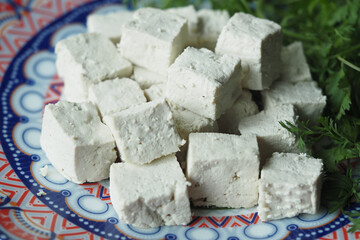 top view of slice of tofu on a chopping board on table 