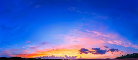 Fototapeta premium Majestic cloud formations illuminated by sunset colors.